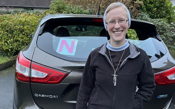 Sr. Kathryn Press poses with N plates on her car (N for novice driver). After moving to Ireland and passing a driving test, Press had to keep the plates on her car for two more years. (Courtesy of Kathryn Press)