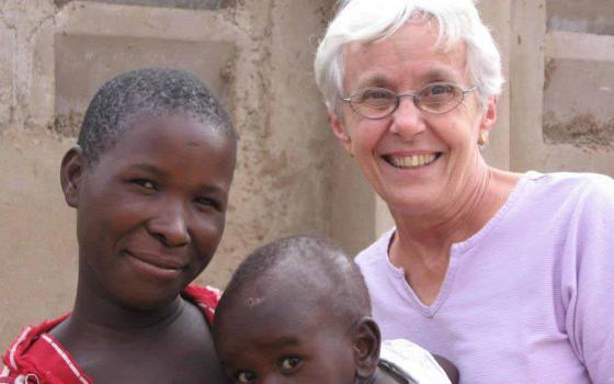 Sr. Connie Krautkremer of the New York-based Maryknoll Sisters served for nearly 50 years in Tanzania. Here she is with a mother and child she worked with during that time. (Courtesy of Sr. Connie Krautkremer)