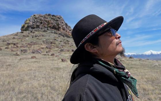Gary McKinney, a spokesman for People of Red Mountain and a member of the nearby Duck Valley Shoshone-Paiute Tribe, walks near Sentinel Rock on April 25, 2023, outside of Orovada, Nev. The Reno-Sparks Indian Colony is abandoning its 3-year lawsuit aimed at blocking a lithium mine currently under construction at Thacker Pass in northwest Nevada.