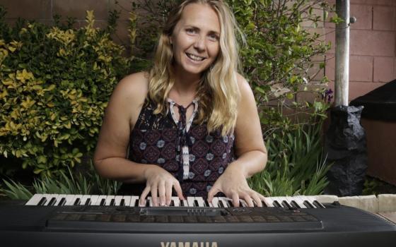 Josephite Sr. Sally Koch plays piano. 