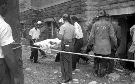 Firefighters and ambulance attendants remove a covered body from the 16th Street Baptist Church in Birmingham, Ala., Sept. 15, 1963, after a deadly explosion detonated by members of the Ku Klux Klan during services.