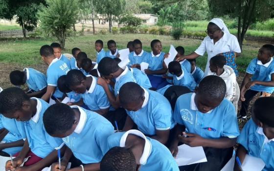 Students take exams outdoors at St. Mary's Comprehensive High School in Ndop, located in the central northwest region of Cameroon.
