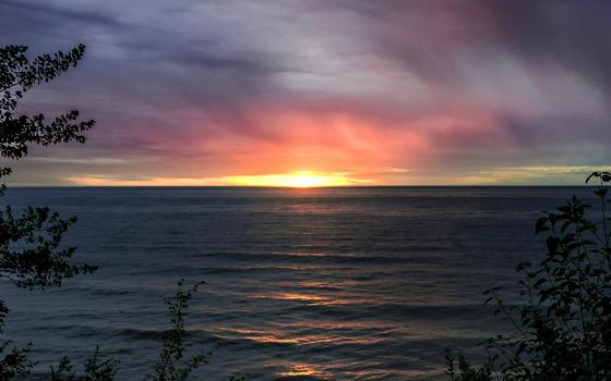 A view from Michigan of a sunset on Lake Superior (Unsplash/Alan Labisch)