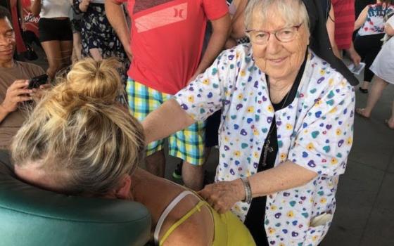 Sr. Rosalind Gefre gives a therapeutic massage in 2018 at a St. Paul Saints minor league baseball game.