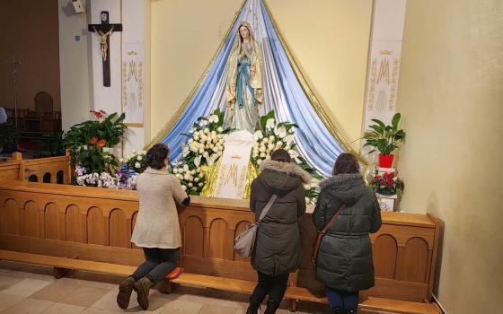 Pilgrims to the Marian shrine in Medjugorje, Bosnia and Herzegovina, pray at the Church of St.  James. 