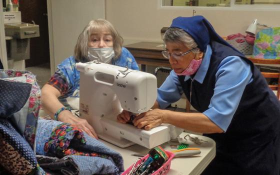 Sr. Milagros Federico assists a student in a sewing class at Give Me a Chance, a nonprofit operated by the Daughters of Charity of St. Vincent de Paul that empowers low-income women and children. (Courtesy of Give Me a Chance/Marissa Konkol)