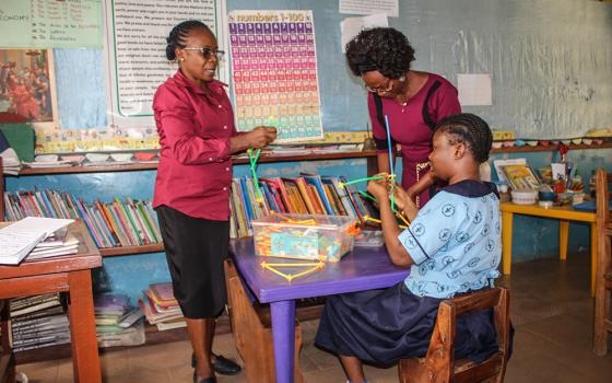 Philomena Ekwe (left), one of the teachers at St. Louis Nursery and Primary School, Akure, constructs shapes using colorful straws. The school is a community-based rehabilitation center where the Sisters of St. Louis provide holistic intervention for persons with disabilities. (GSR photo/Valentine Benjamin)