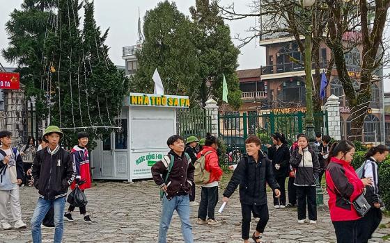 Hmong students from the Sa Pa Parish-run hostel head to school in cold weather on Dec. 12, 2023, in Sa Pa town, Vietnam. (Joachim Pham)