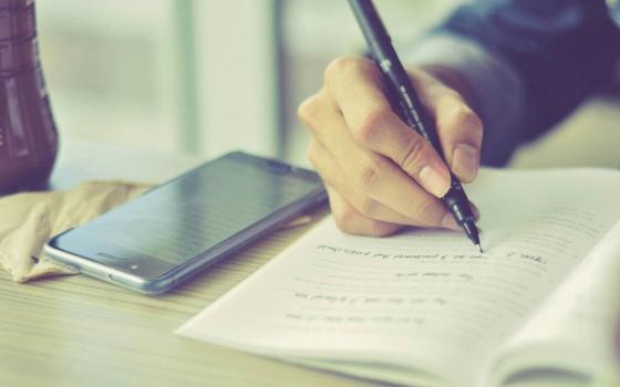 Person writing in notebook