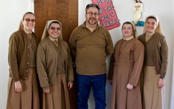 Dan Stockman, national correspondent for Global Sisters Report, stands with Missionary Servants of the Divine Spirit sisters in Michigan in 2015. 