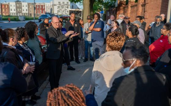 Archdiocese of Baltimore's Auxiliary Bishop Bruce Lewandowski speaks to an overflow crowd attending a special Seek the City To Come meeting for the Black Catholic community April 23, 2024, outside St. Frances Academy in Baltimore. The archdiocese released its final plan for parish planning in the city May 22. 