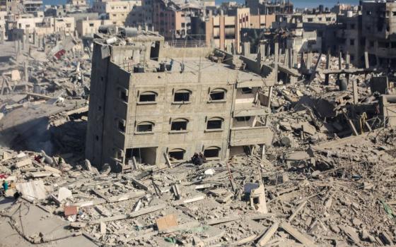 Palestinian men sit amid the rubble of destroyed houses and buildings at the area around Al Shifa Hospital amid the ongoing conflict between Israel and Hamas, in Gaza City April 1. 