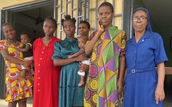 Young women and girls at the Ozanam House pose for a photo with Sr. Mary Okeke, program coordinator at the Ozanam House. (Valentine Benjamin)