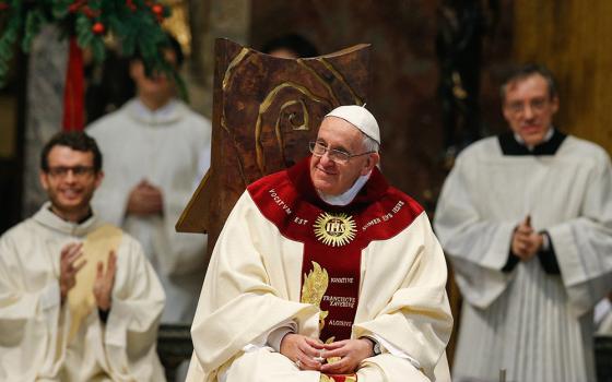 Pope Francis smiles during Mass at the Society of Jesus' Church of the Gesù in Rome Jan. 3, 2014. The pope celebrated Mass with 300 of his Jesuit confreres in thanksgiving for the canonization of Jesuit St. Peter Faber. (CNS/Paul Haring)