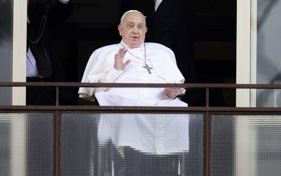 Pope Francis waves to a crowd of well-wishers at Rome's Gemelli hospital before returning to the Vatican March 23, 2025, after 38 days of treatment at the hospital. (CNS/Pablo Esparza)