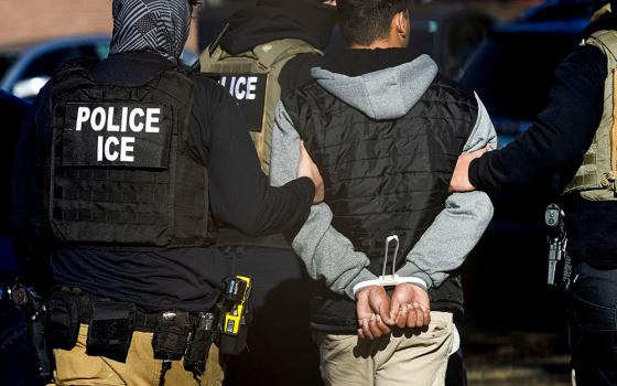 Agents with the Immigration and Customs Enforcement detain a man after conducting a raid at the Cedar Run apartment complex in Denver Feb. 5, 2025. (OSV News/Reuters/Kevin Mohatt)