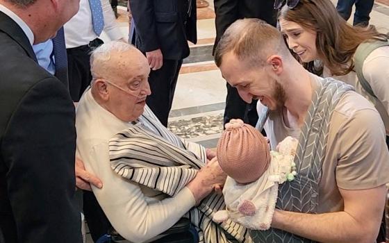 Pope Francis, who is continuing to recover from pneumonia and a long hospitalization, blesses a baby as he makes a surprise visit to St. Peter's Basilica at the Vatican, April 10, 2025, in this screengrab taken from a handout video. (OSV News/Reuters/Luiz Gil)