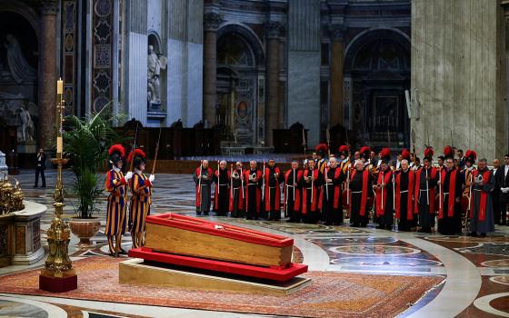 Members of the Swiss Guard stand next to the coffin containing Pope Francis' body, on the day of the translation of his body, in St. Peter's Basilica at the Vatican, April 23, 2025. (OSV News photo/Yara Nardi, Reuters)