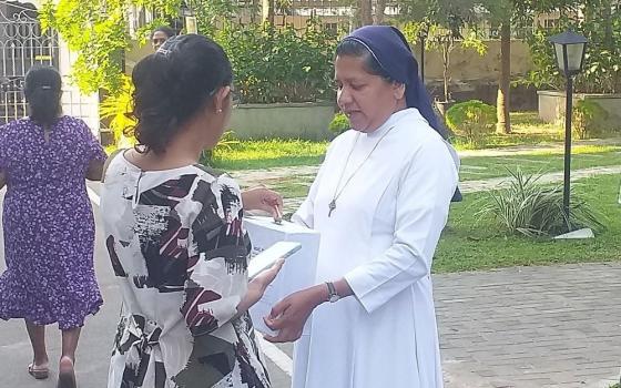 nun collects donations.