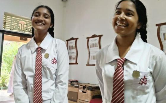 2 girls in school uniforms
