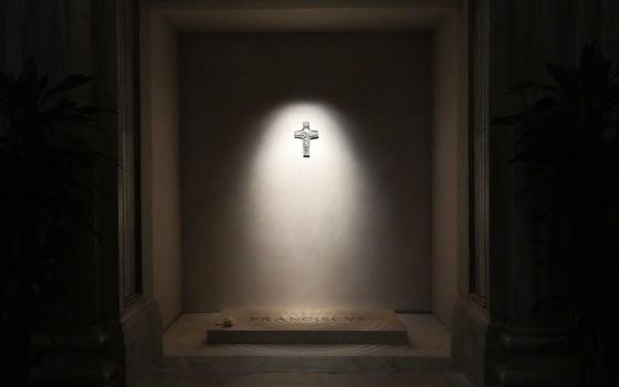 A light shines on a replica of Pope Francis' pectoral cross above his tomb in the side aisle of Rome's Basilica of St. Mary Major early April 27, 2025. (CNS/Lola Gomez)