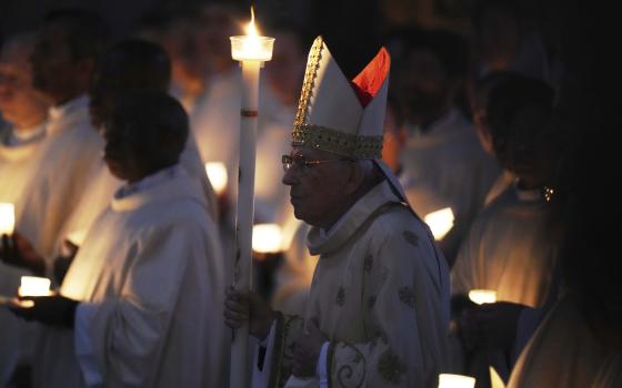 Dean of the College of Cardinals Giovanni Battista Re leads the Easter vigil inside St. Peter's Basilica at the Vatican, Saturday, April 19, 2025. (AP Photo/Alessandra Tarantino)