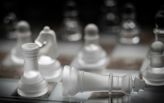 A close-up of a chess board shows translucent pieces (Unsplash/Peter Law)