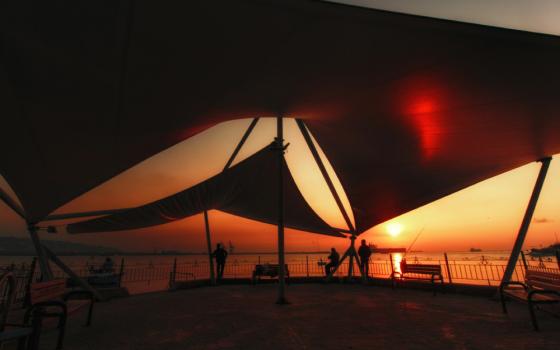 Geometric tent on a beach in Ereğli, Zonguldak, Turkey during a warm sunset.