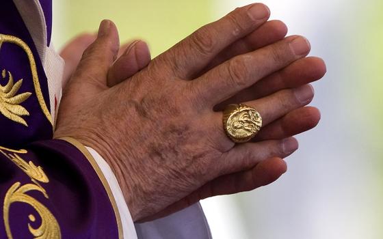 The fisherman's ring — the pope's signet — is seen on the right hand of Pope Benedict XVI as he celebrates Mass in Havana, Cuba, March 28, 2012. When a pope dies or resigns the ring is destroyed in a special ceremony, usually carried out in private. (CNS/Catholic Press Photo/Alessia Giuliani)