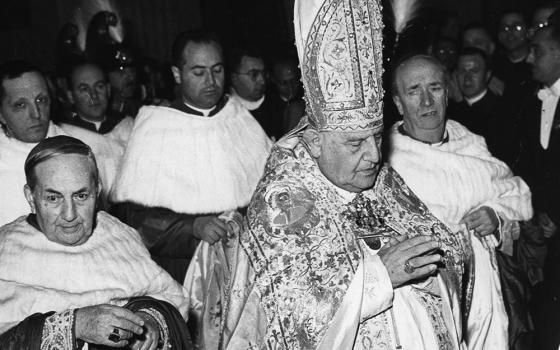Blessed John XXIII prays after his election in 1958 at the Vatican. (CNS)