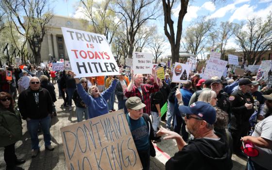 A protester confronts a counter-protester as a large crowd gathers outside the courthouse in Prescott, Ariz., April 5, 2025, to protest against U.S. President Donald Trump's administration. Opponents of Trump and billionaire Elon Musk rallied across the U.S. to protest the administration’s actions on government downsizing, the economy, human rights and other issues. (OSV News/Bob Roller)