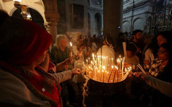 Christian worshippers light candles on the day of Easter Sunday Mass in the Church of the Holy Sepulchre in Jerusalem's Old City, on April 20, 2025. (OSV News/Reuters/Ronen Zvulun)