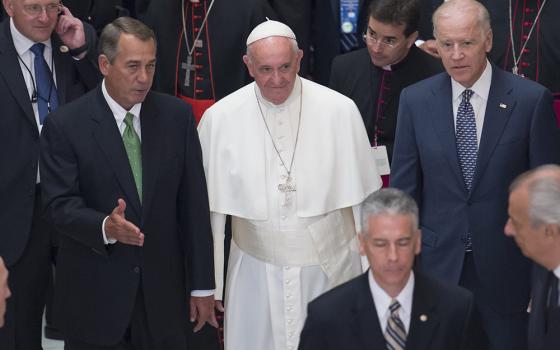 Pope Francis walks down the aisle with then-U.S. Speaker of the House John Boehner and then-Vice President Joe Biden after delivering an address to a joint session of Congress at the U.S. Capitol in Washington Sept. 24, 2015. Biden attended the April 26, 2025, funeral of Francis, who died April 21 at age 88.(OSV News/Michael Reynolds, pool via Reuters)