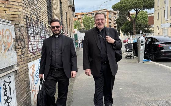 Cardinal Joseph Tobin of Newark, N.J., and his secretary, Fr. Anthony Palombo, walk from the subway stop to Mass at Santa Maria delle Grazie, the cardinal's titular church in Rome, May 4, 2025. (CNS/Cindy Wooden)