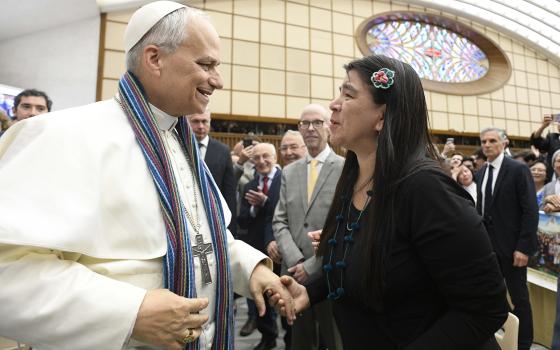 ope Leo XIV greets a woman in the Paul VI Audience Hall at the Vatican May 12, 2025, during a meeting with representatives of the media who covered his election. (OSV News photo/Vatican Media)