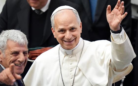 Pope Leo XIV greets photographers as he welcomes members of the media who covered his election, during a meeting in the Paul VI Audience Hall at the Vatican May 12, 2025. (CNS/Lola Gomez)