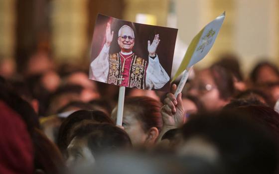 Someone holds a placard with an image of Pope Leo XIV on the day of a Mass at the Cathedral of Santa Maria de Chiclayo in Peru May 10, 2025, celebrating the election of Pope Leo XIV May 8 at the Vatican. The new pope was bishop of Chiclayo between 2015 and 2023. (OSV News/Reuters/Sebastian Castaneda)