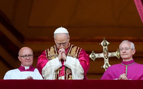 Pope Leo XIV, the former Cardinal Robert F. Prevost, prays as he stands on the central balcony of St. Peter’s Basilica at the Vatican after his election as pope May 8, 2025. The new pope was born in Chicago. (CNS/Lola Gomez)