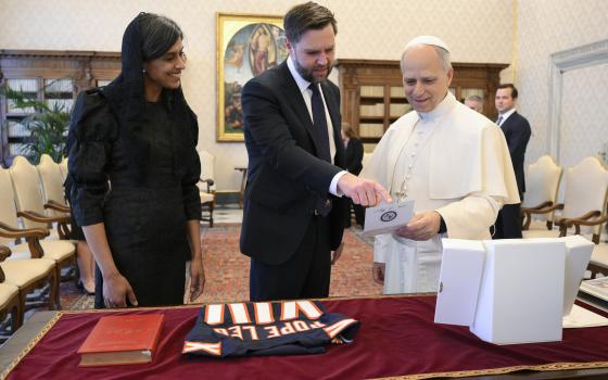 Usha Vance smiles as her husband, U.S. Vice President JD Vance, presents a gift to Pope Leo XIV in the library of the Apostolic Palace at the Vatican May 19, 2025. (CNS photo/Vatican Media)