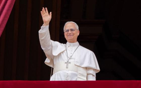 Pope Leo XIV waves to the crowd from the central balcony of St. Peter's Basilica at the Vatican as he leads, for the first time, the midday recitation of the "Regina Coeli" prayer May 11, 2025. (CNS/Lola Gomez)