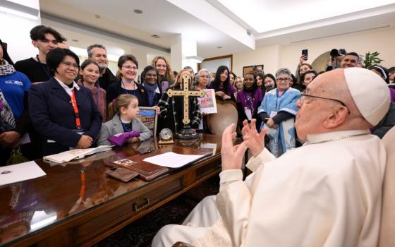 Pope Francis meets members and supporters of Talitha Kum in his residence at the Vatican Feb. 7, 2025, the International Day of Prayer and Awareness against Human Trafficking, which he established. Maryknoll Sr. Abby Avelino, international coordinator of Talitha Kum, is seen in front of the pope. (CNS/Vatican Media)