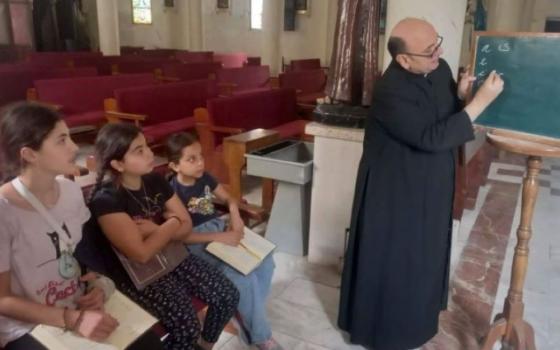 Priest at blackboard