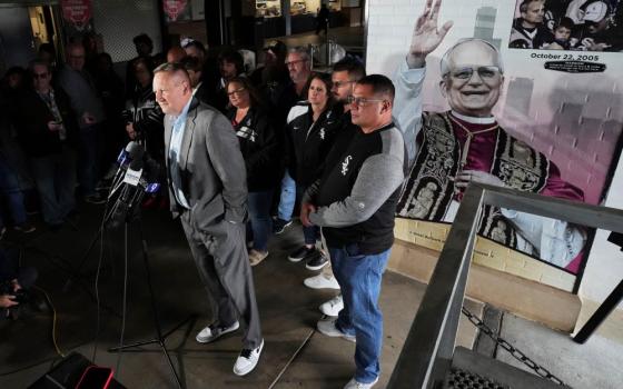 Press conference with sign honoring Pope Leo XIV