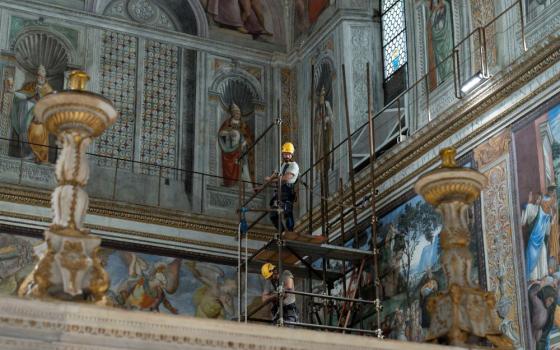 Workers prepare Sistine Chapel.