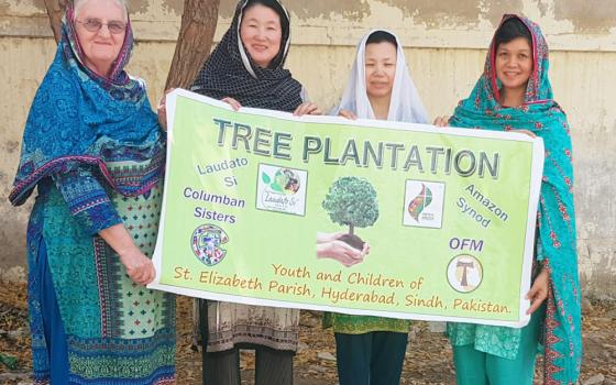 From left: Srs. Rebecca Conlon, Yoonmi Kim, Ha-suk Shin, and Anne Carbon, Columban Sisters from Latifabad, Hyderabad, in Pakistan, participate in a demonstration on Nov. 6, 2019, advocating for greening initiatives in Hyderabad following the 2019 Amazon synod. (Jawed Munawar)