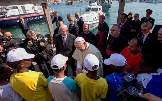 Pope Francis talks with migrants at the port in Lampedusa, Italy, July 8, 2013. (CNS/Pool via Reuters)