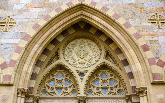 The tympanum above the central entrance to the Cathedral of the Holy Cross in Boston (Wikimedia Commons/Farragutful)
