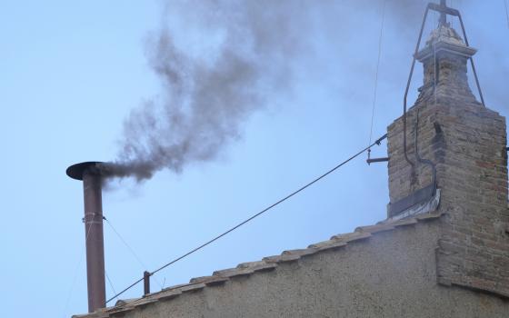 Black smoke billows from the chimney of the Sistine Chapel during the conclave to elect a new pope, at the Vatican, Thursday, May 8, 2025. (AP Photo/Andrew Medichini)