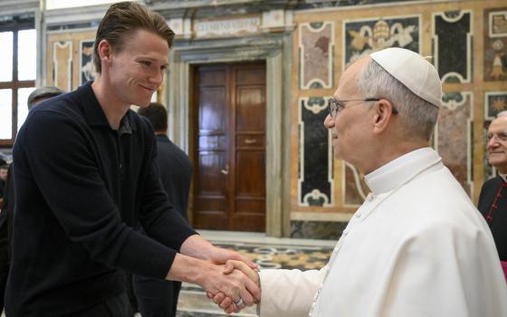 Napoli soccer team's midfielder Scott McTominay, left, shakes hands with Pope Leo XIV during a papal private audience with the team in the Clementine Hall at the Vatican on May 27, 2025. (Vadican Media via AP)