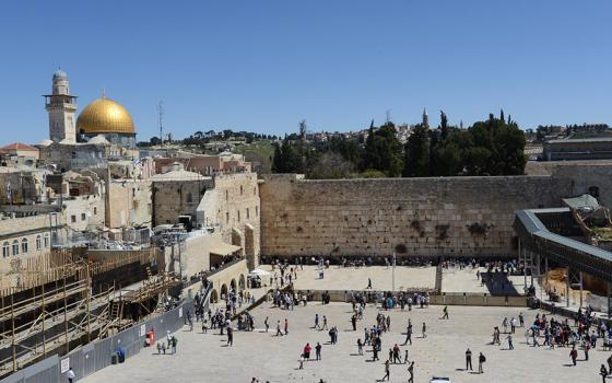 Pilgrims walk near the Western Wall, Judaism's holiest site, in the Old City of Jerusalem in this March 28, 2014, file photo. (CNS/Debbie Hill)